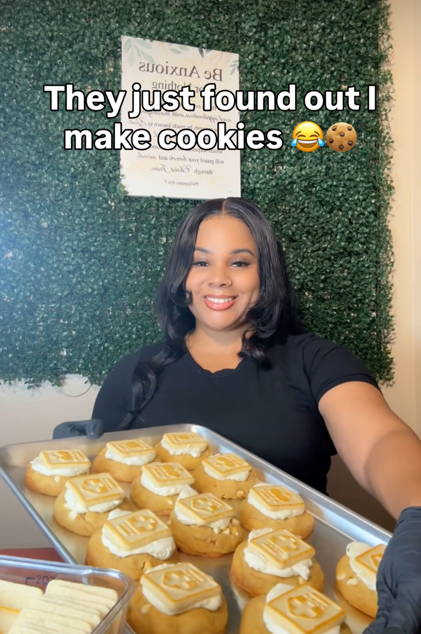 The owner and baker of Blessed Batch holding a fresh tray of cookies