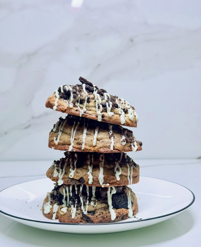 Stack of four cookies n cream cookies with white chocolate drizzle
